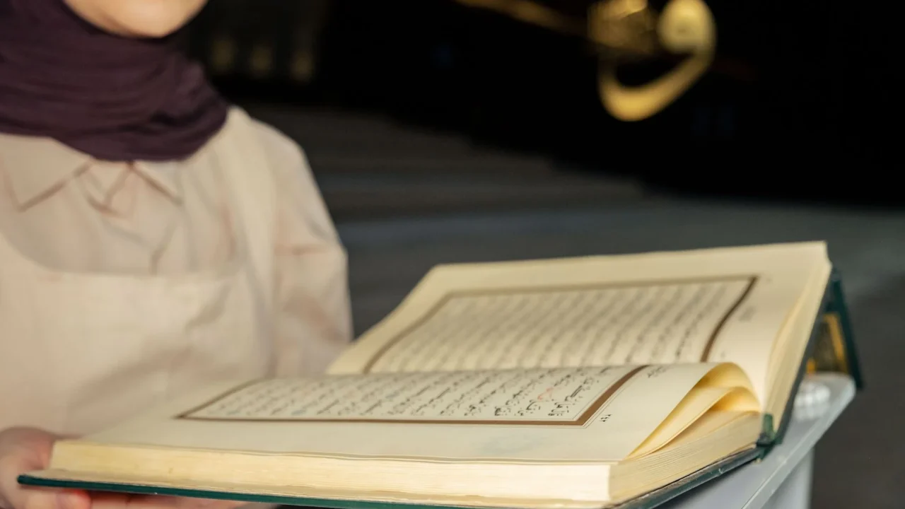 teacher reading quran book